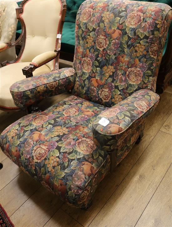 A Victorian club armchair, with floral upholstery, on short turned legs